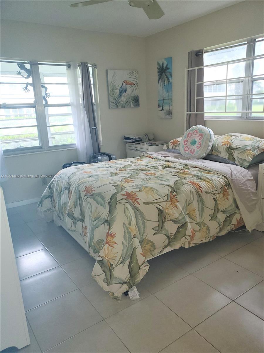 550 Mansfield M, Unit 550 Boca Raton, FL 33434 - Photo 5 of 14 a bedroom with a bed and window