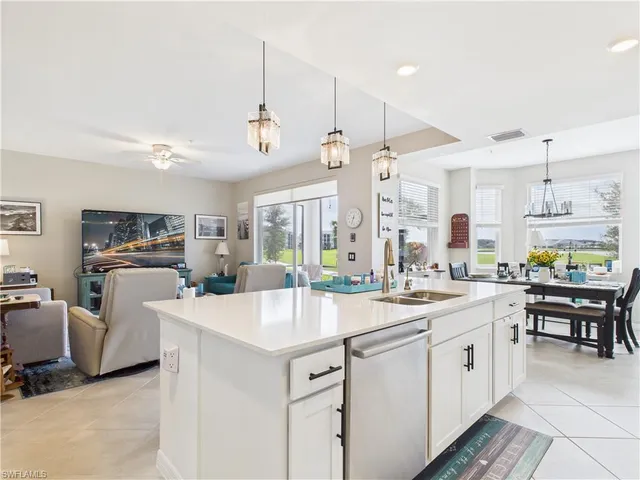 a large white kitchen with a large window