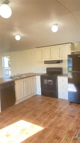 a view of kitchen and empty room
