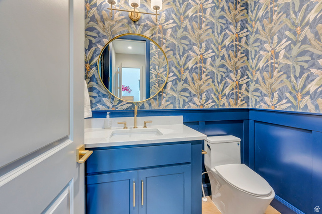 250 South Main Street, Unit 10 Alpine, UT 84004 - Photo 8 of 29 Vanity with a white countertop and gold-finish faucet, paired with a round gold-finish mirror