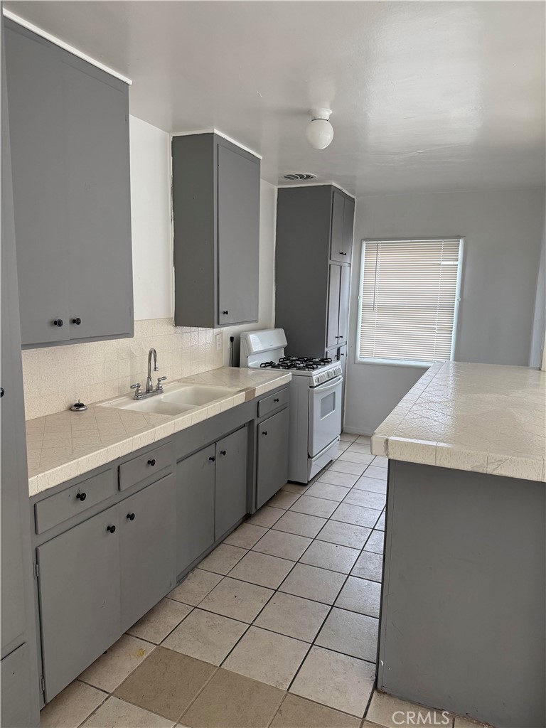 12102 Preston Street Grand Terrace, CA 92313 - Photo 12 of 20 a spacious bathroom with a double vanity sink mirror and