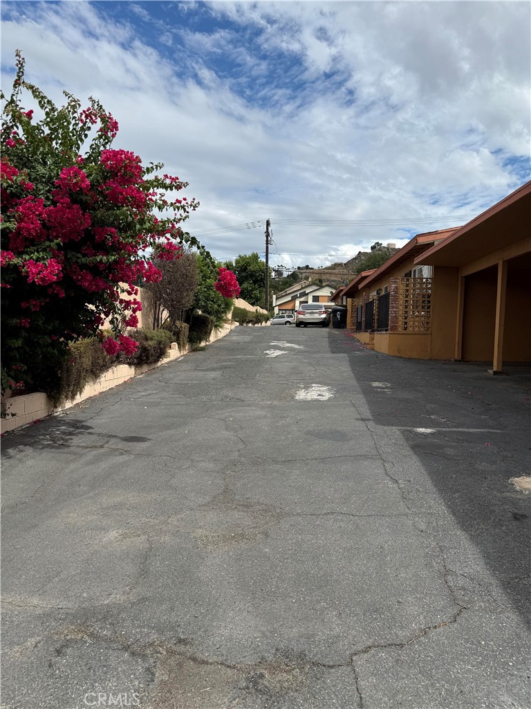 12102 Preston Street Grand Terrace, CA 92313 - Photo 20 of 20 a view of a garage with a flower plants and large tree