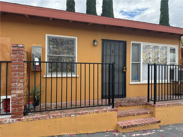 a view of a house with a small backyard