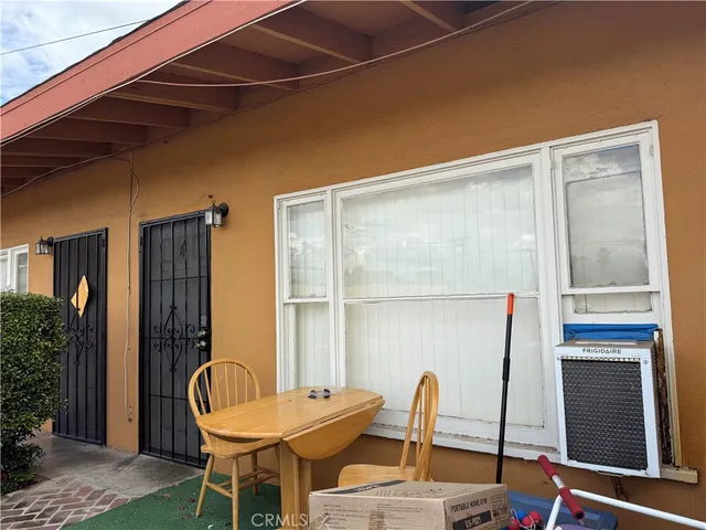 a backyard of a house with table and chairs