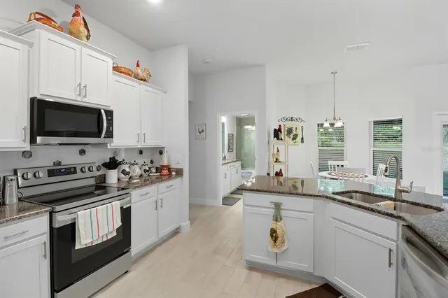 a kitchen with a sink stove and microwave