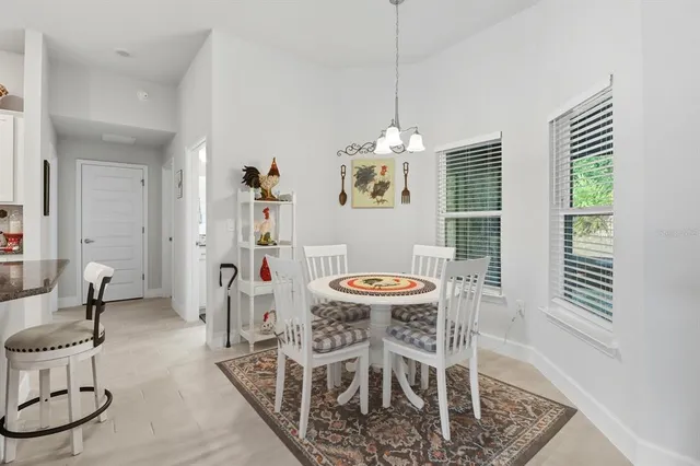 a view of a dining room with furniture wooden floor and chandelier