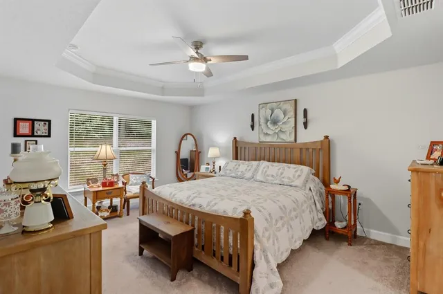 a bedroom with bed and wooden floor