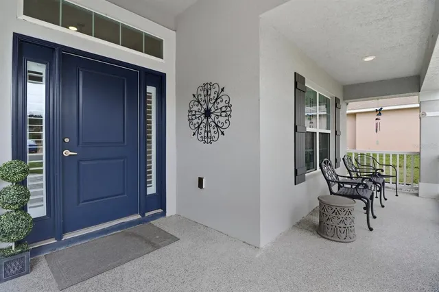 a dining room with furniture and potted plants