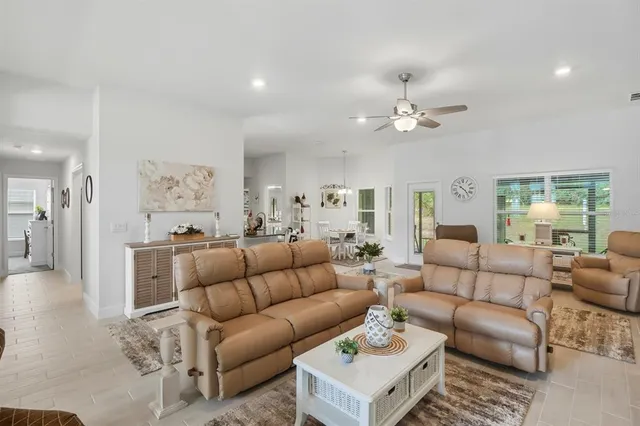 a living room with furniture ceiling fan and a rug