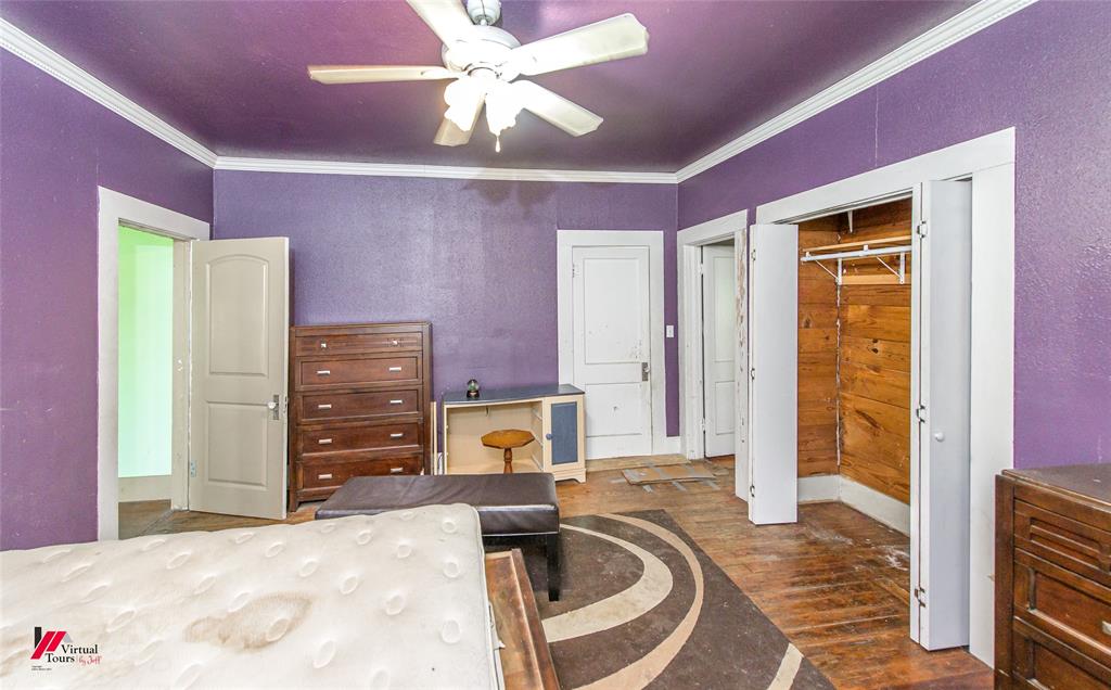 179 Daniel Thomas Road Springhill, LA 71075 - Photo 16 of 37 Bedroom featuring a closet, crown molding, wood finished floors, and ceiling fan