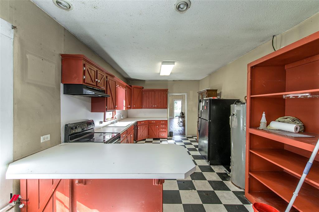 179 Daniel Thomas Road Springhill, LA 71075 - Photo 22 of 37 Kitchen featuring light countertops, under cabinet range hood, dark floors, a sink, and black appliances