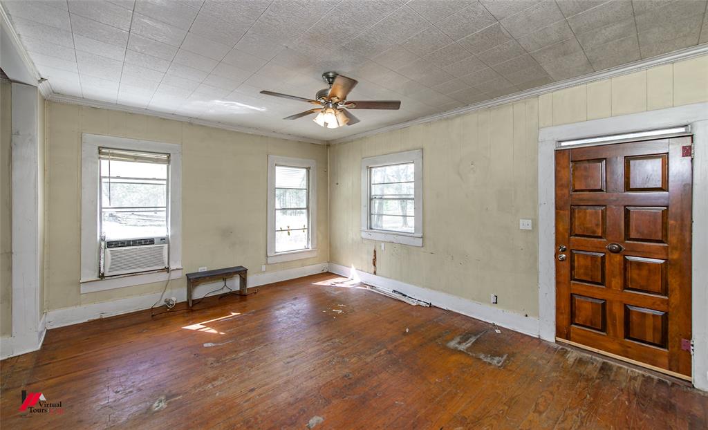179 Daniel Thomas Road Springhill, LA 71075 - Photo 4 of 37 Foyer entrance with crown molding, baseboards, a ceiling fan, hardwood / wood-style floors, and cooling unit
