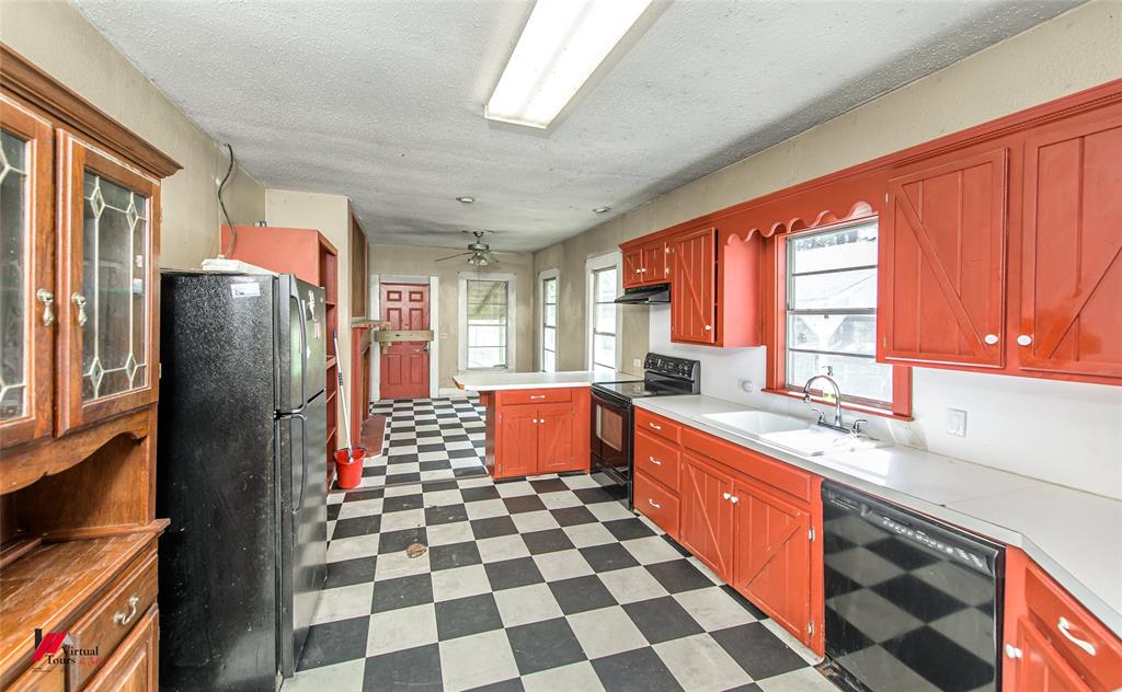 179 Daniel Thomas Road Springhill, LA 71075 - Photo 7 of 37 Kitchen featuring dark floors, a sink, plenty of natural light, and black appliances