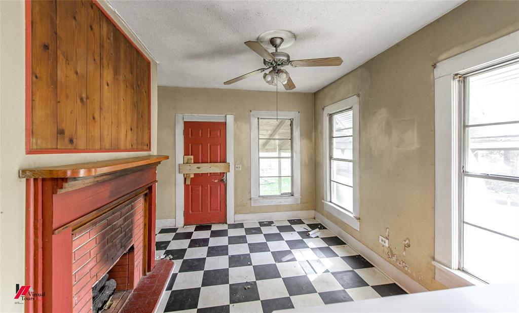 179 Daniel Thomas Road Springhill, LA 71075 - Photo 9 of 37 Entryway with baseboards, a fireplace, a ceiling fan, and dark floors