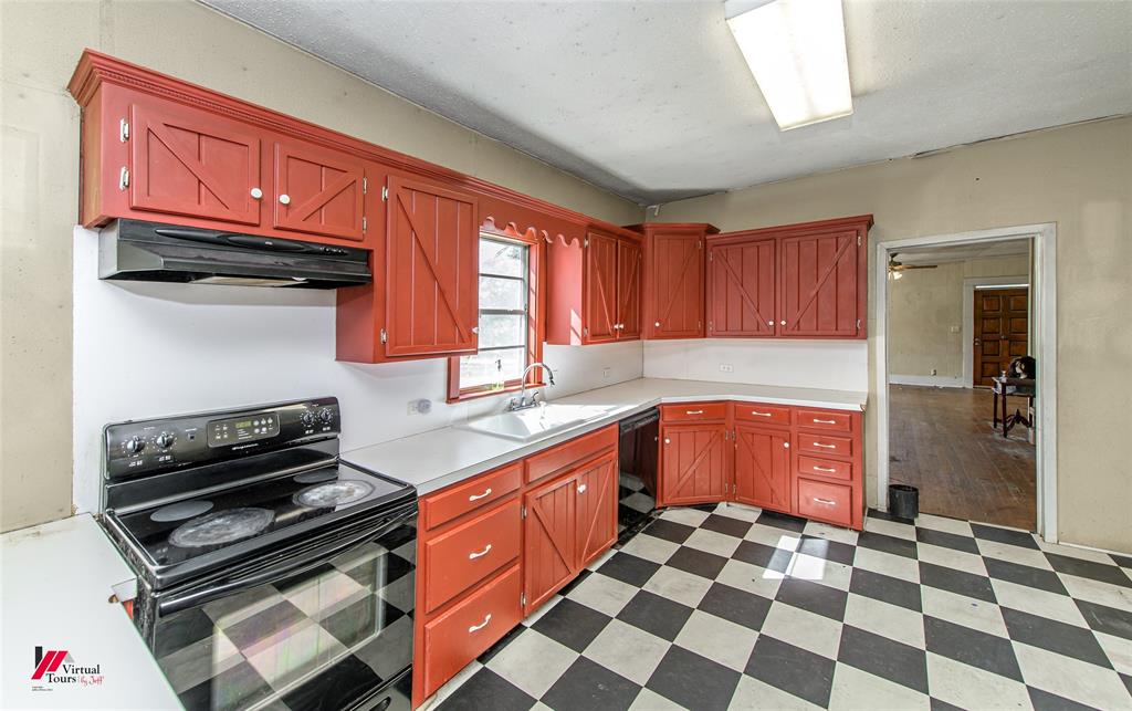 179 Daniel Thomas Road Springhill, LA 71075 - Photo 10 of 37 Kitchen featuring light countertops, tile patterned floors, under cabinet range hood, a sink, and black appliances