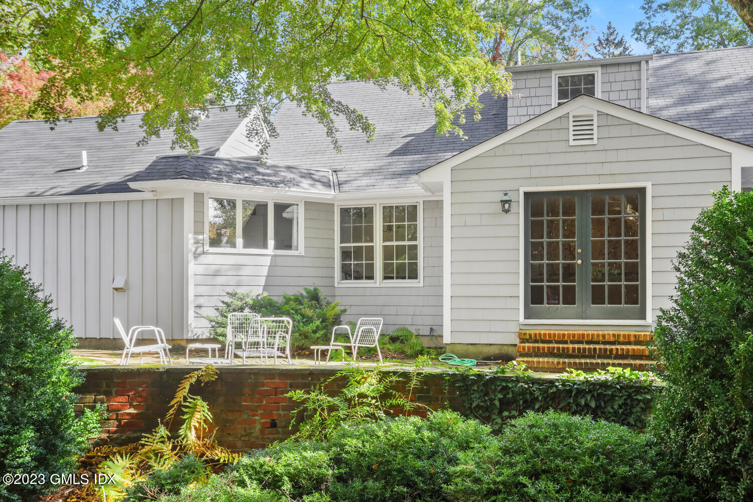 35 Ridgeview Avenue Greenwich, CT 06830 - Photo 15 of 16 a front view of a house with a yard