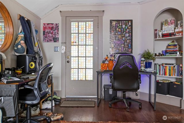 a view of a workspace with furniture and a window