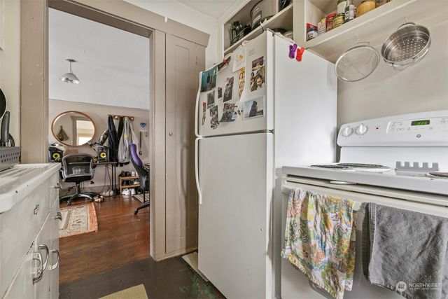 a kitchen with stainless steel appliances granite countertop a refrigerator and a stove