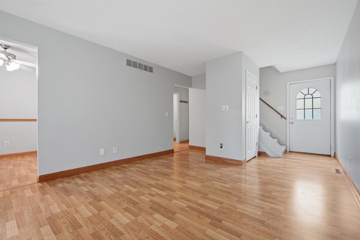 1532 Hunt Drive, Unit A Normal, IL 61761 - Photo 5 of 25 a view of an empty room with wooden floor and a window