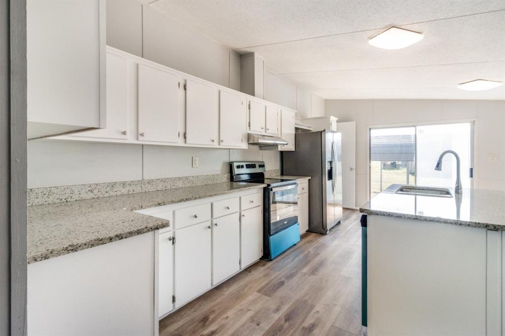 7066 Mitchell Drive Terrell, TX 75160 - Photo 1 of 1 a kitchen with stainless steel appliances granite countertop a sink stove and refrigerator
