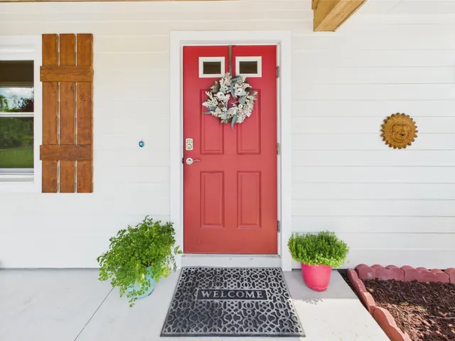 a bed sitting in a spacious bedroom next to a window