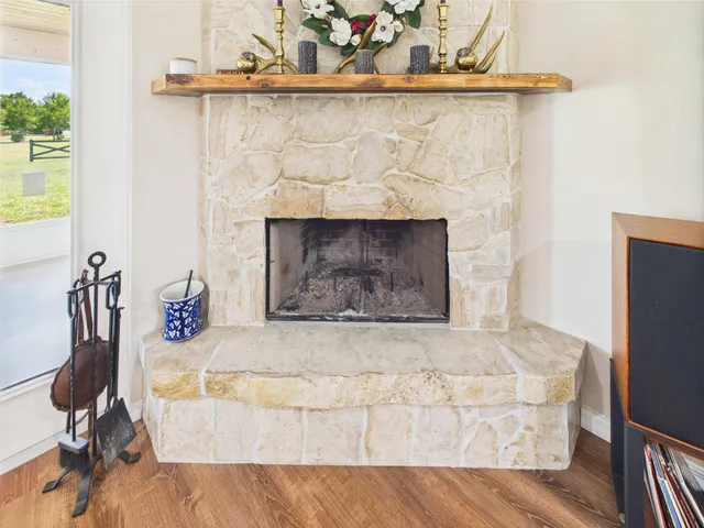 a view of a hallway with wooden floor and a bathroom