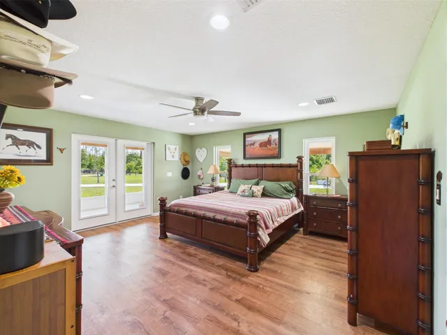 a en suite bathroom with a granite countertop sink and a mirror