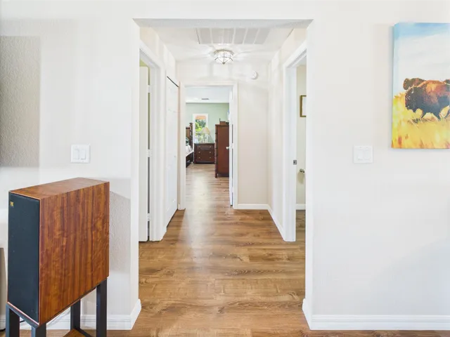 a view of a house with a big yard and large trees