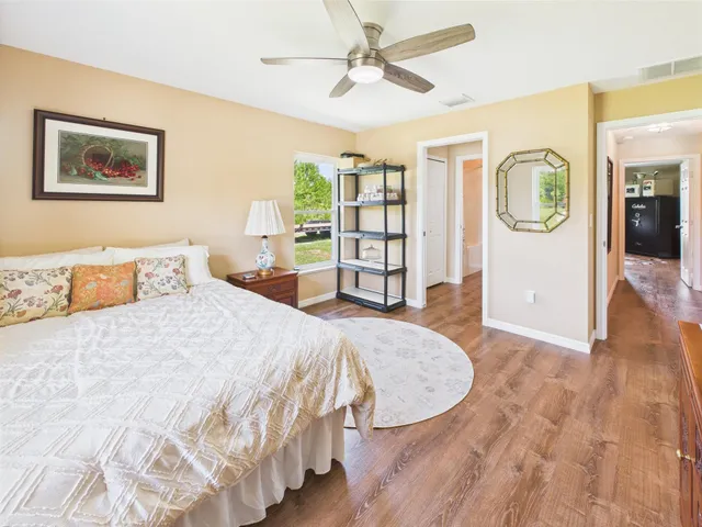 a view of a house with a big yard and a large tree