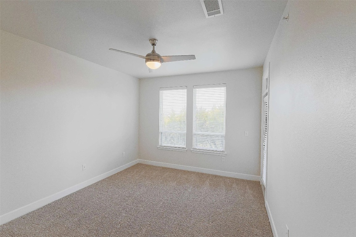4800 Steiner Ranch Boulevard, Unit 20002 Austin, TX 78732 - Photo 21 of 29 Empty room with light colored carpet and ceiling fan