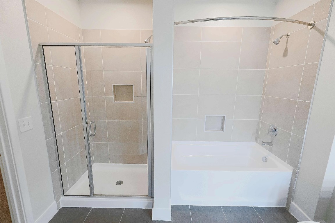 4800 Steiner Ranch Boulevard, Unit 20002 Austin, TX 78732 - Photo 24 of 29 Full bath with a shower stall, dark tile patterned flooring, and a bath