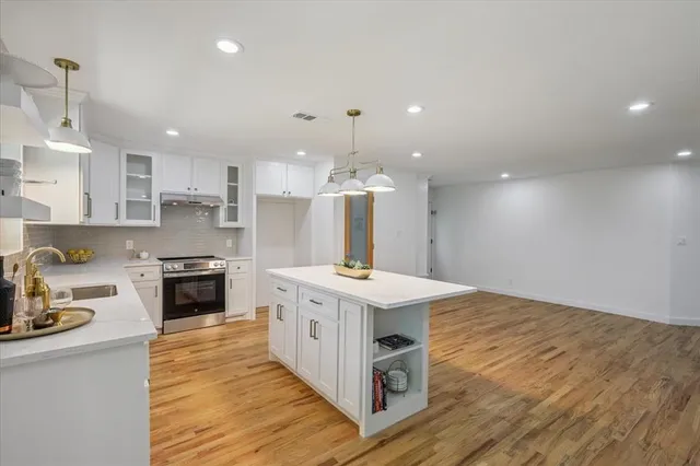 a kitchen with a stove a sink and a refrigerator