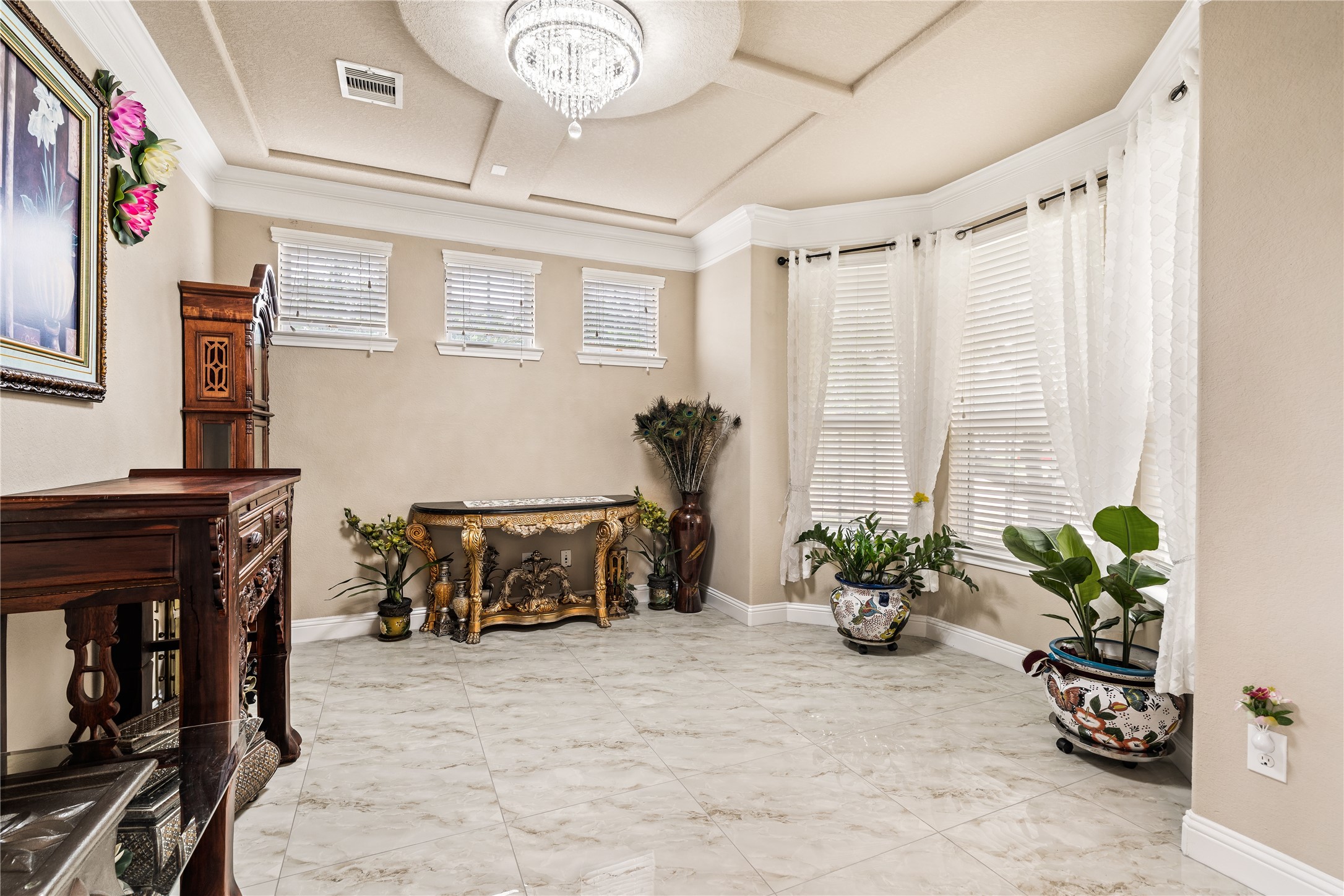 5802 Layton Meadows Lane Spring, TX 77379 - Photo 5 of 42 Formal flex room / study. Tray ceiling with crystal chandelier, bay windows, crown molding, gold console table, marble tile floors. Great flex space.