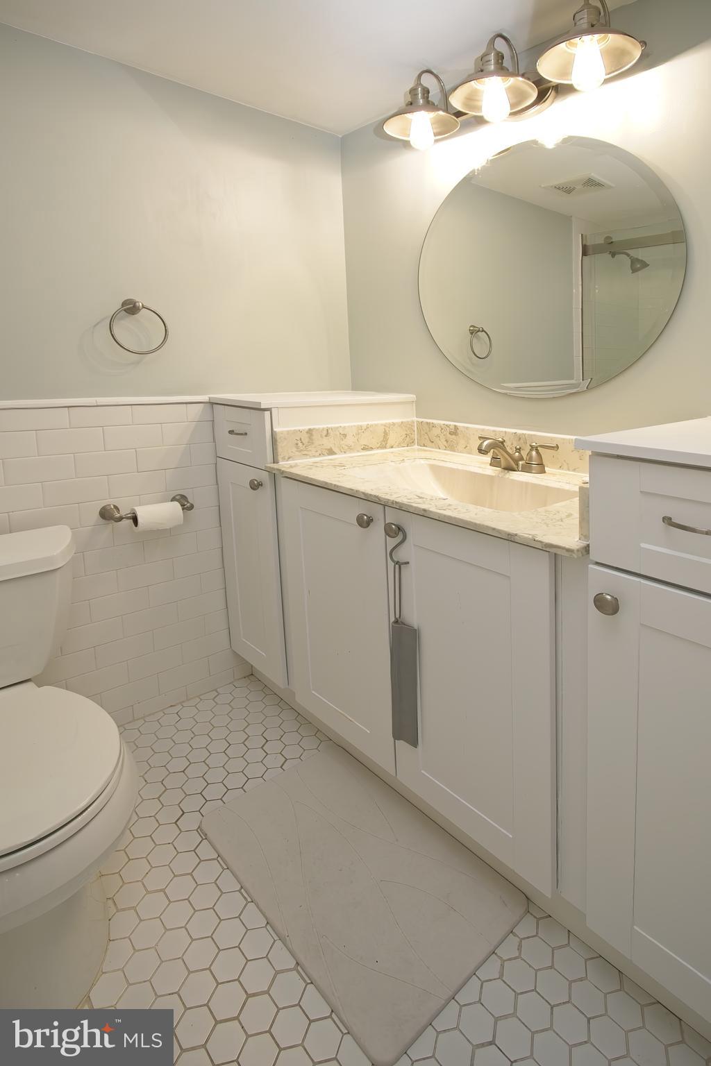 2104 Green Watch Way, Unit 301 Reston, VA 20191 - Photo 13 of 33 Custom vanity, lighting and round mirror