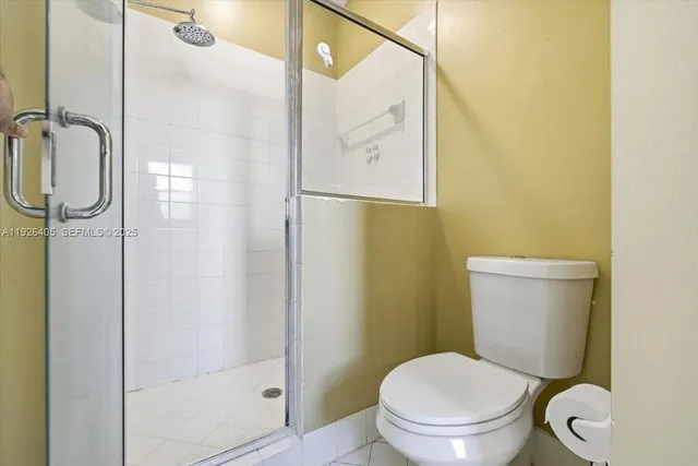 a white toilet sitting next to a bathroom sink