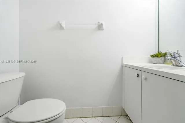 a white toilet sitting next to a bathroom sink