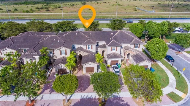 an aerial view of residential house with outdoor space and swimming pool