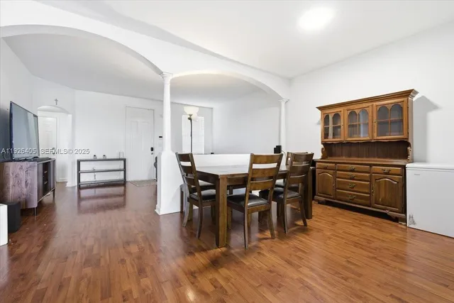 a view of a dining room with furniture and wooden floor