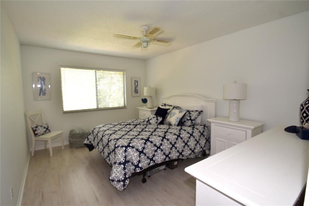 1709 Pelican Cove Road, Unit GL446 Sarasota, FL 34231 - Photo 11 of 25 a bedroom with two beds and a dresser