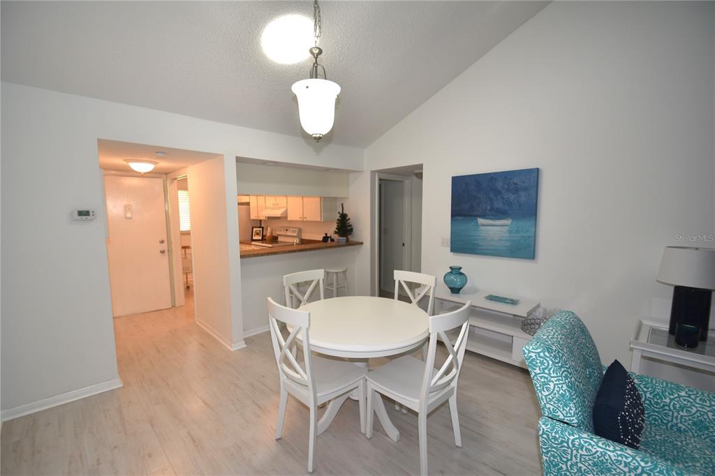 1709 Pelican Cove Road, Unit GL446 Sarasota, FL 34231 - Photo 13 of 25 a view of a dining room with furniture and wooden floor