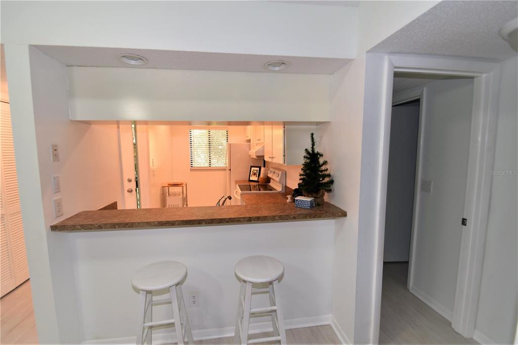 1709 Pelican Cove Road, Unit GL446 Sarasota, FL 34231 - Photo 3 of 25 a dining table with chairs and window