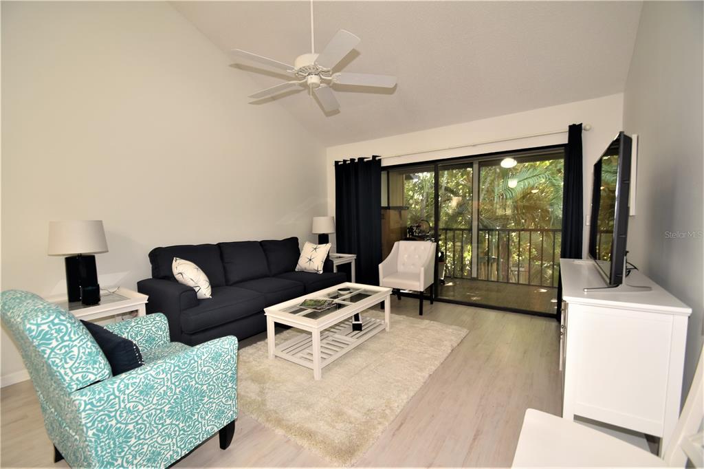 1709 Pelican Cove Road, Unit GL446 Sarasota, FL 34231 - Photo 4 of 25 a living room with furniture and a large window