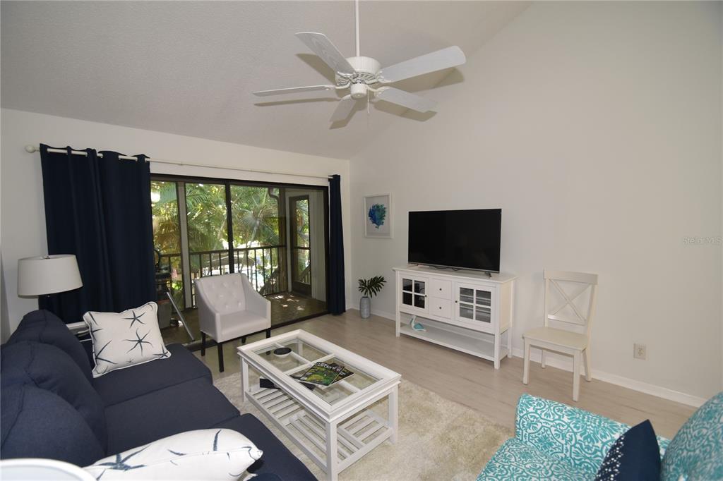 1709 Pelican Cove Road, Unit GL446 Sarasota, FL 34231 - Photo 5 of 25 a living room with furniture and a flat screen tv