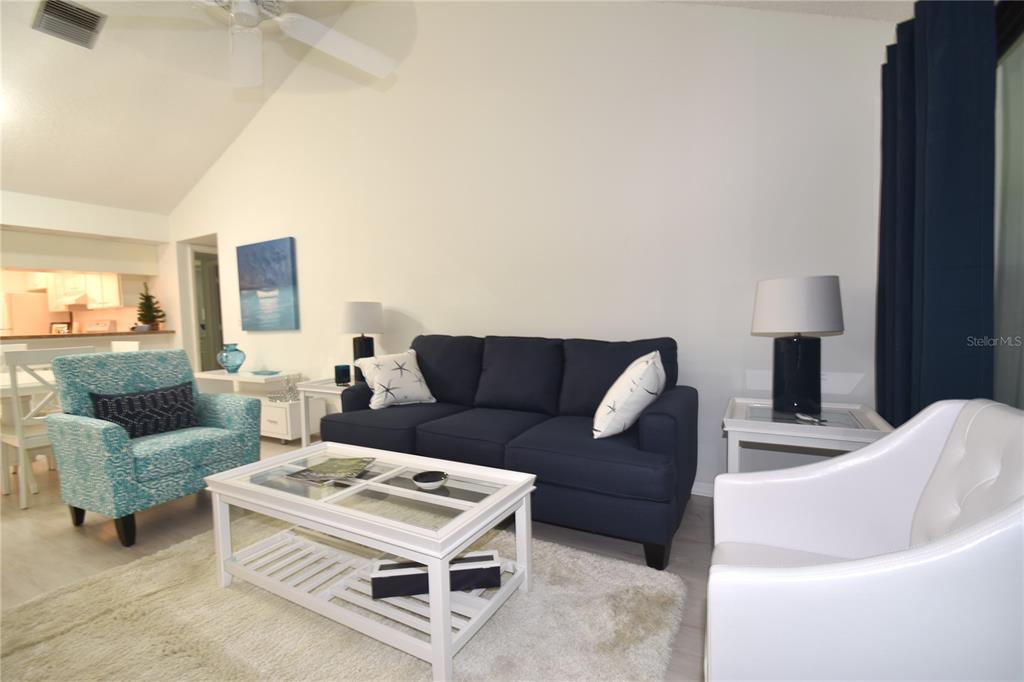 1709 Pelican Cove Road, Unit GL446 Sarasota, FL 34231 - Photo 9 of 25 a living room with furniture and a fireplace