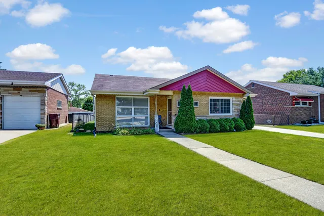 a front view of a house with a garden