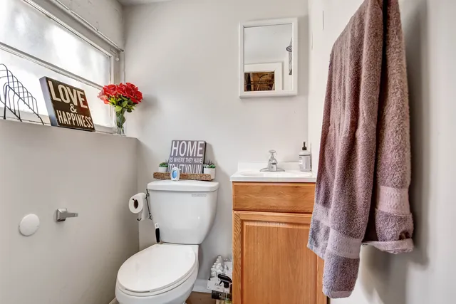 a bathroom with a toilet sink and mirror