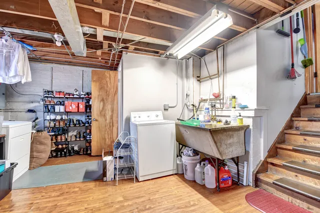a utility room with dryer washer and a wooden floors