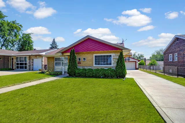 a front view of a house with a garden