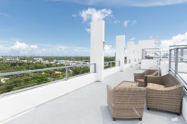 8101 Biscayne Boulevard, Unit R414 Miami, FL 33138 - Photo 2 of 27 a living room with furniture a bed and a chandelier