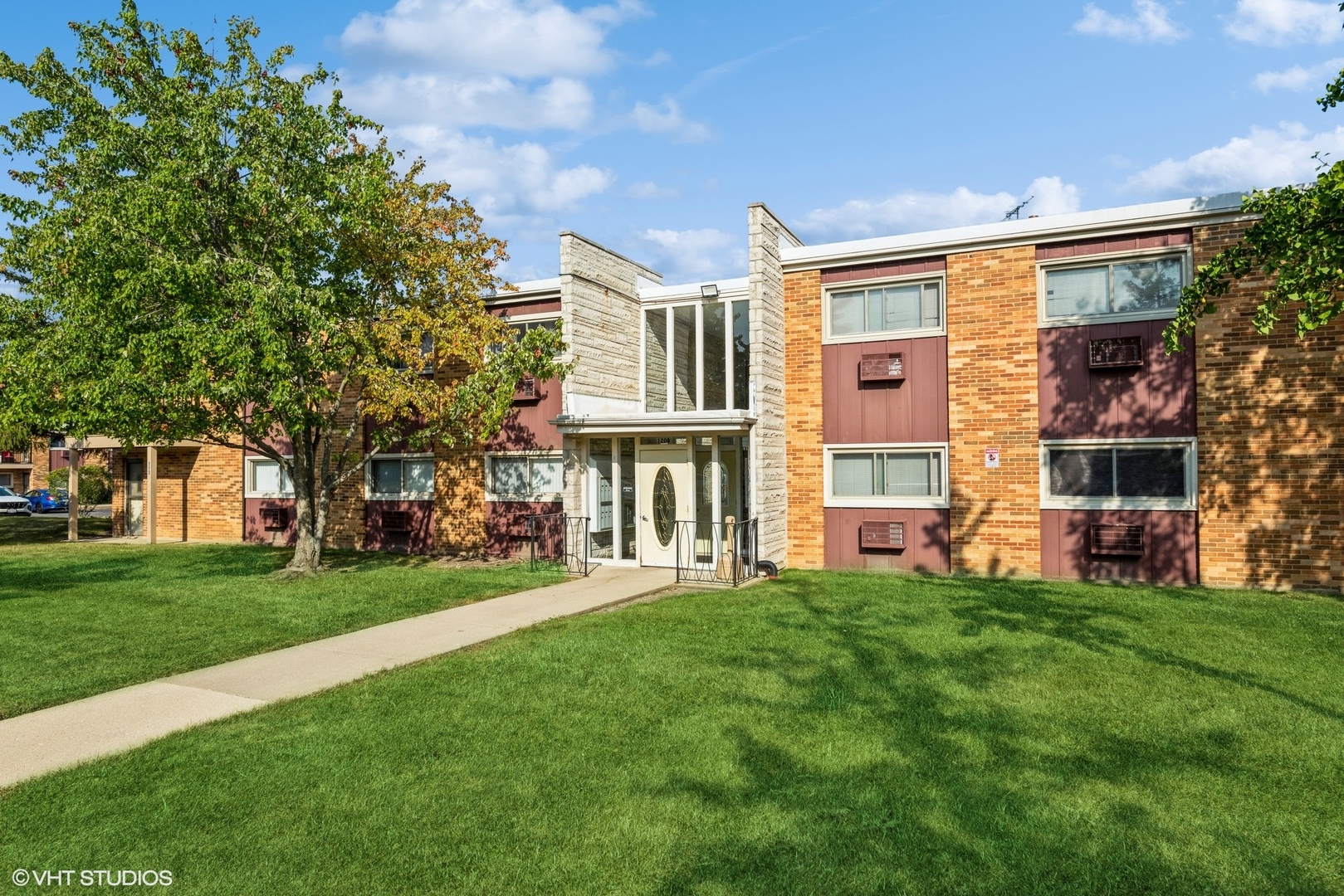 120 Collen Drive, Unit 212 Lombard, IL 60148 - Photo 1 of 12 a front view of a house with a yard